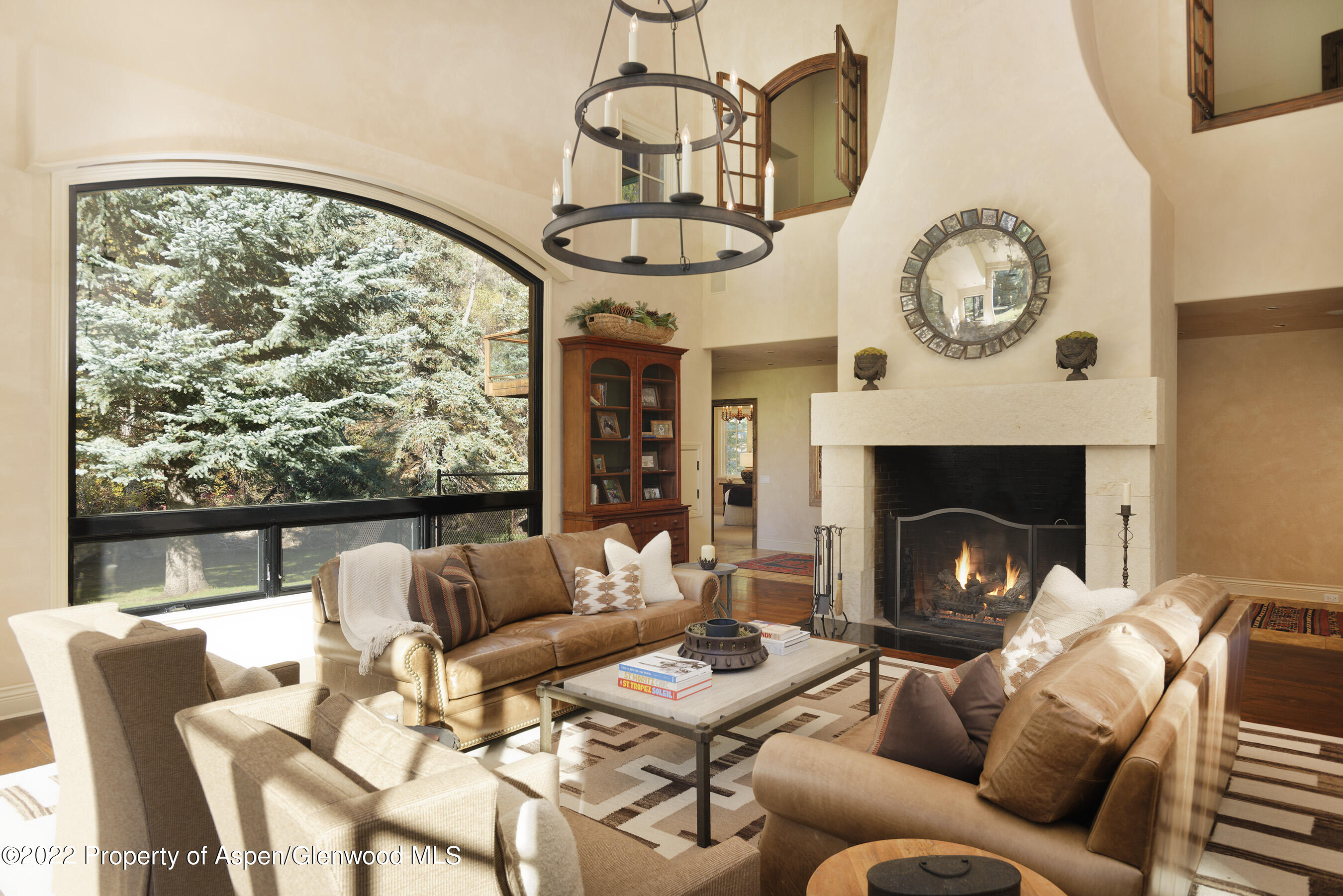 333 Snowmass Creek Road Snowmass, CO 81654 - Photo 4 of 41 a living room with furniture a clock and a fireplace