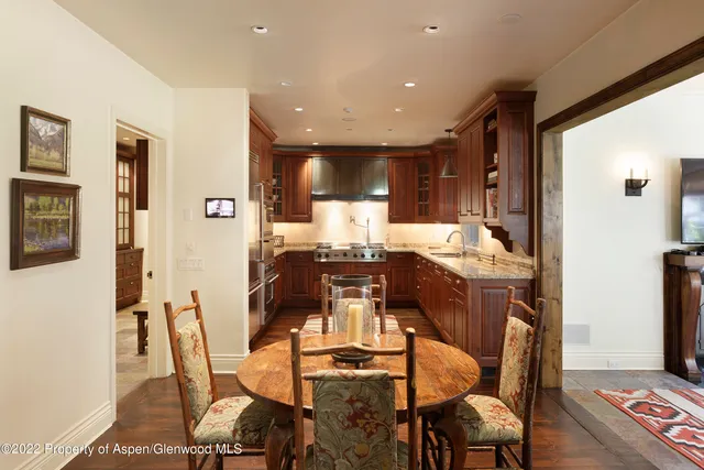 a dining room with furniture and wooden floor