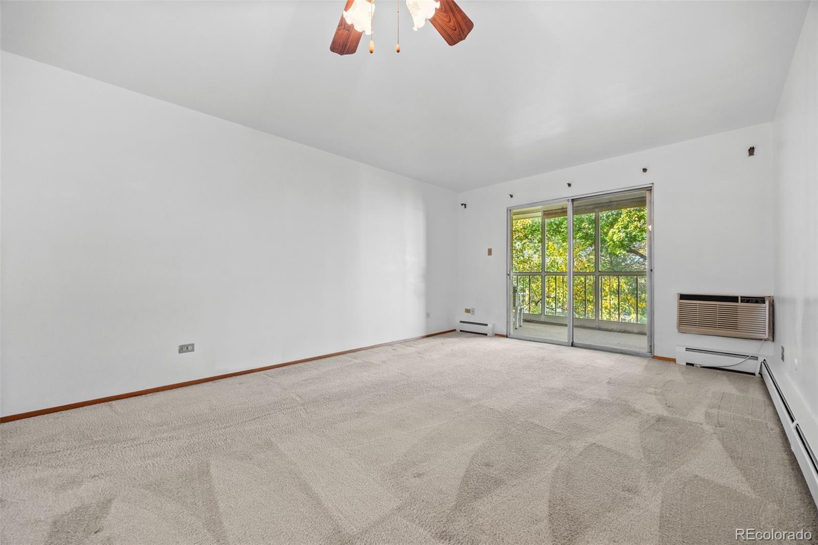 755 South Clinton Street, Unit 7B Denver, CO 80247 - Photo 12 of 36 a view of an empty room with a window