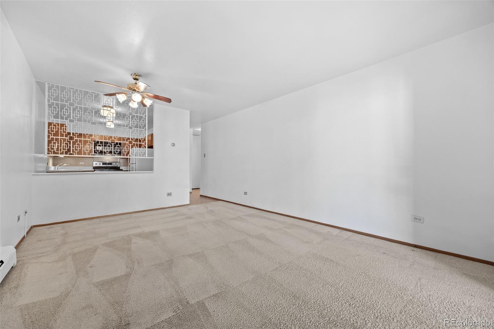 755 South Clinton Street, Unit 7B Denver, CO 80247 - Photo 13 of 36 a view of a big room with window and chandelier fan