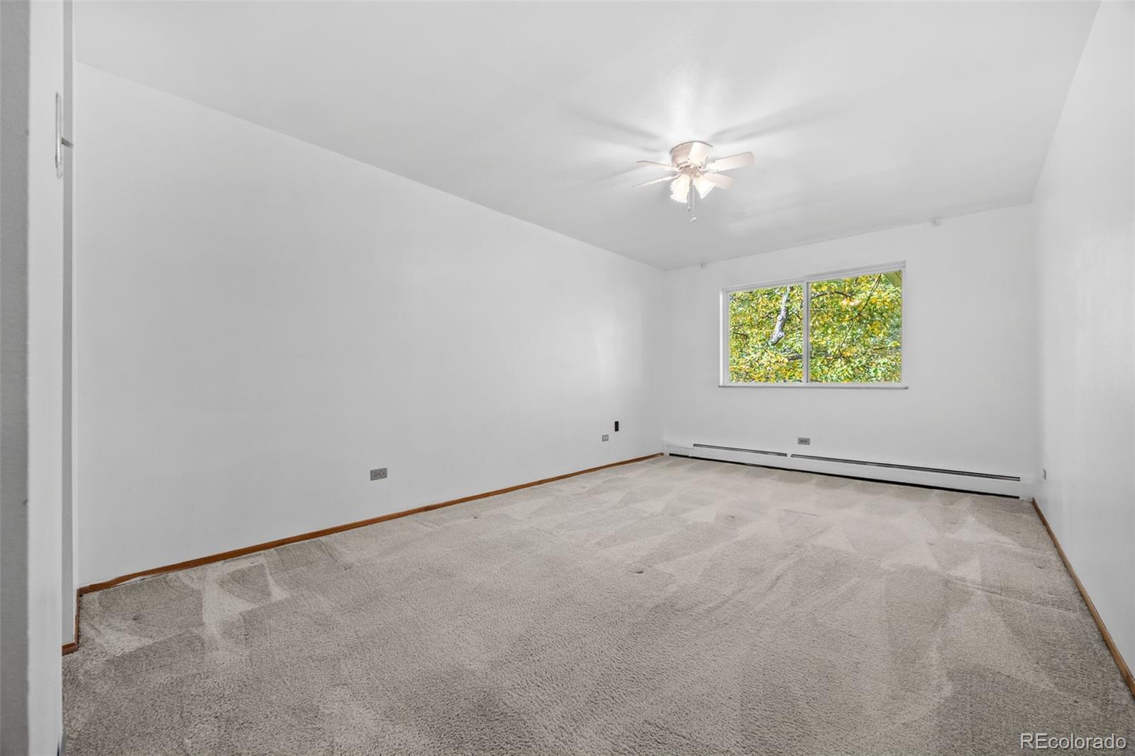 755 South Clinton Street, Unit 7B Denver, CO 80247 - Photo 16 of 36 an empty room with a ceiling fan and a window