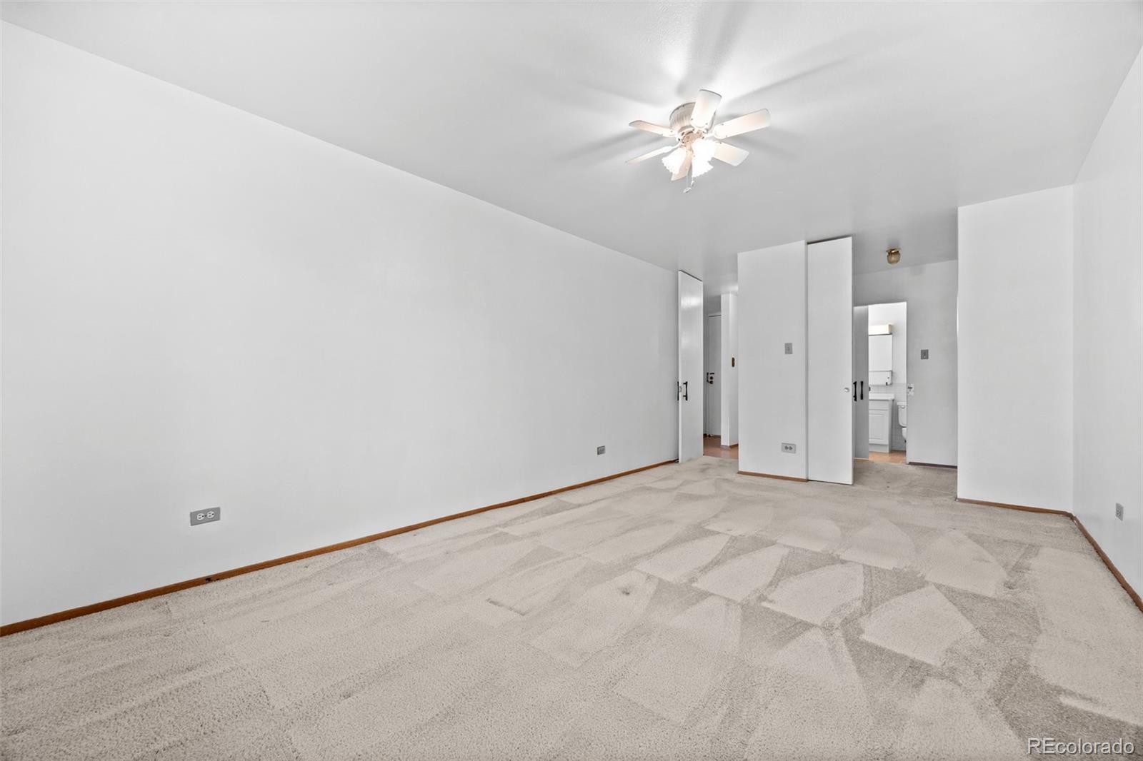 755 South Clinton Street, Unit 7B Denver, CO 80247 - Photo 18 of 36 a view of a room with a ceiling fan and a window