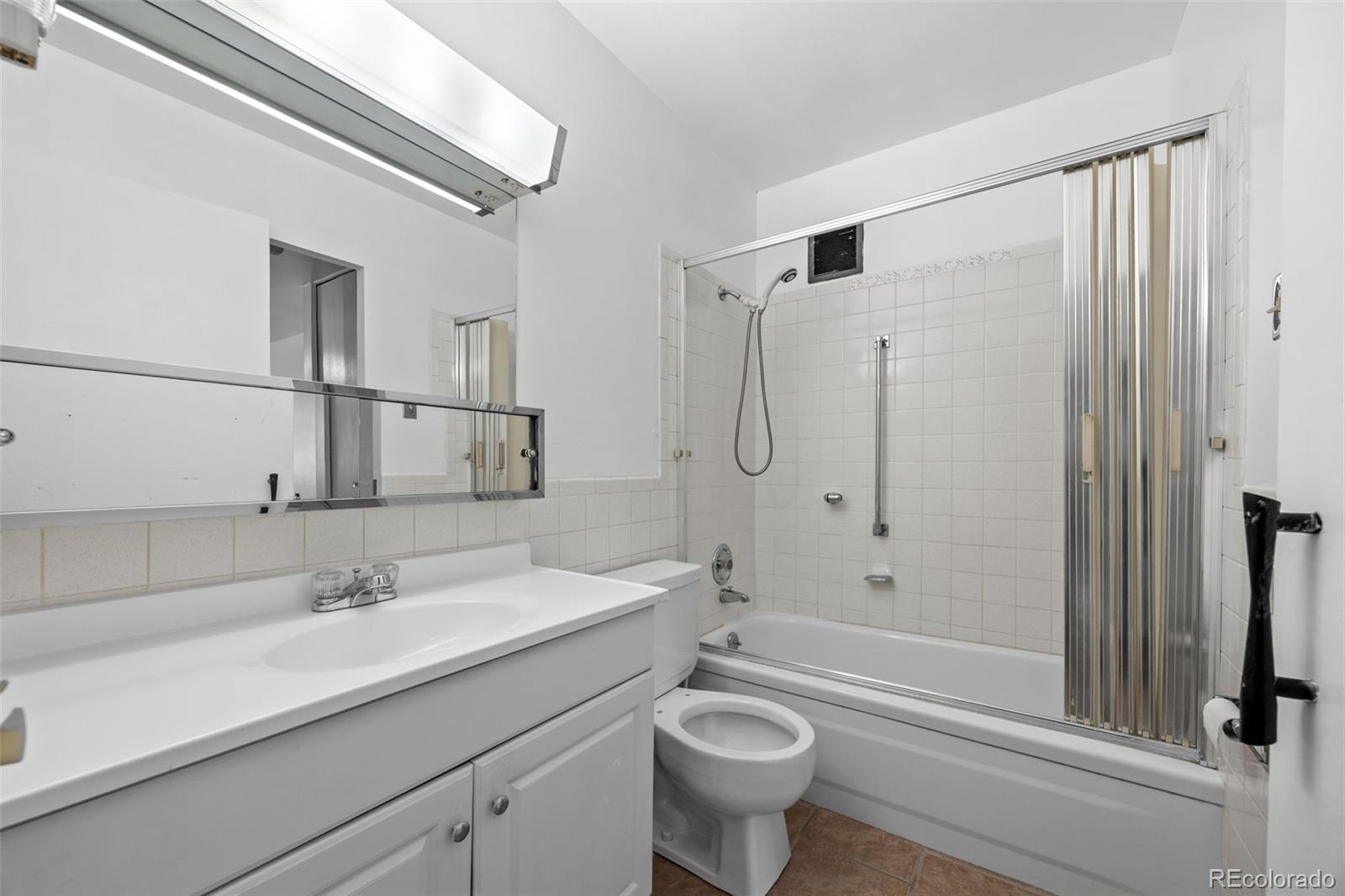 755 South Clinton Street, Unit 7B Denver, CO 80247 - Photo 23 of 36 a bathroom with a sink a toilet and shower