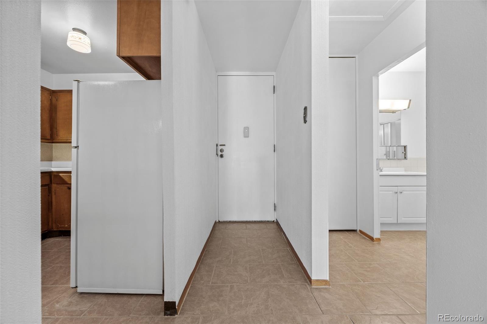 755 South Clinton Street, Unit 7B Denver, CO 80247 - Photo 9 of 36 a view of a hallway with wooden floor
