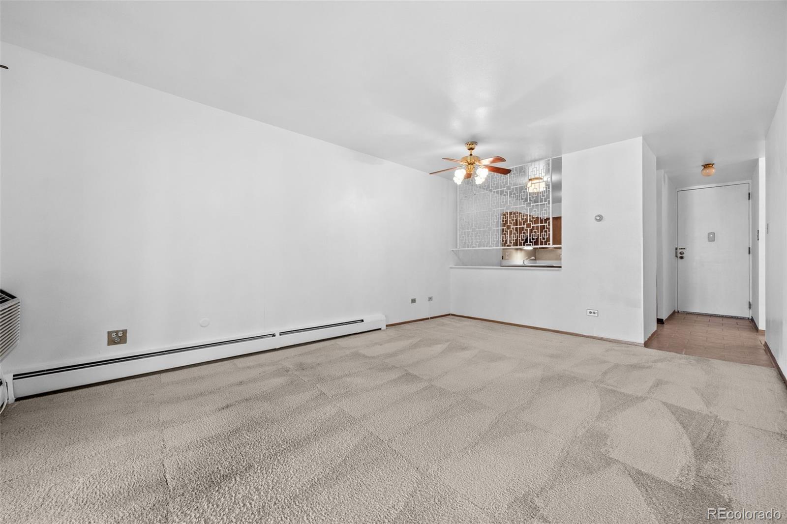 755 South Clinton Street, Unit 7B Denver, CO 80247 - Photo 10 of 36 a view of a room with window and chandelier fan