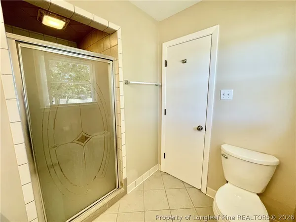 a bathroom with a shower and a toilet