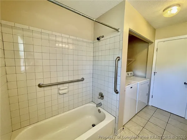 a bathroom with a bathtub and shower