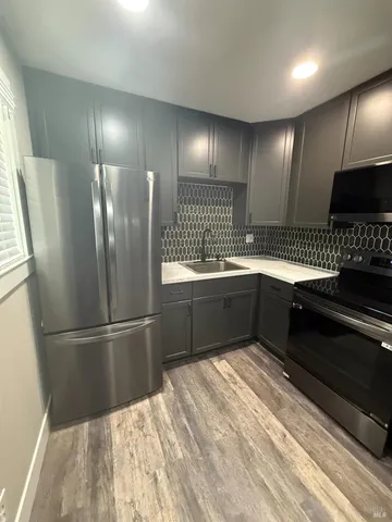 a kitchen with a sink stainless steel appliances and cabinets