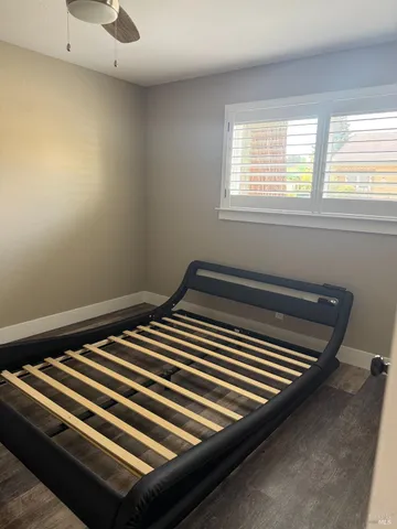 a view of a room with wooden floor and a window