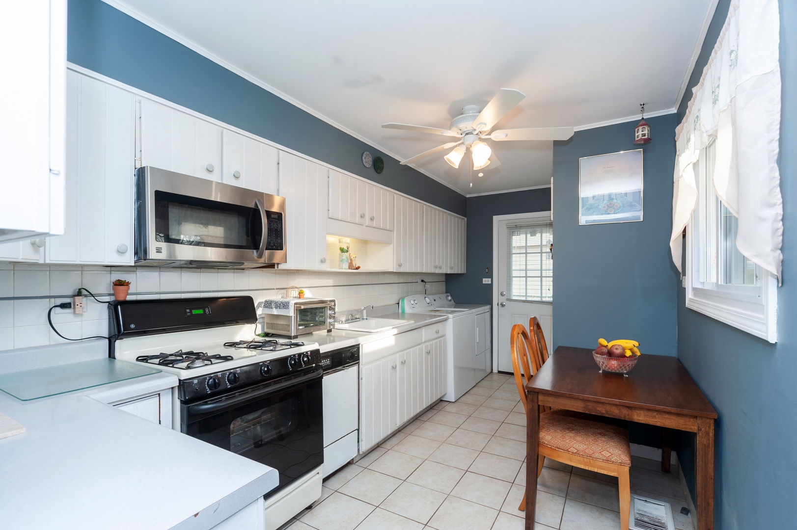 147 George Road Wheeling, IL 60090 - Photo 4 of 11 a kitchen with a stove a sink and a microwave