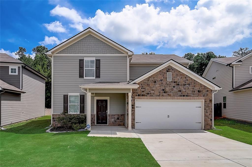 7857 Rudder Circle Fairburn, GA 30213 - Photo 1 of 1 a front view of a house with a garden and yard