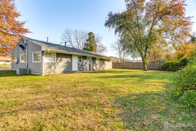 a front view of house with yard and swimming pool
