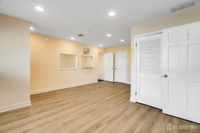 a view of empty room with wooden floor