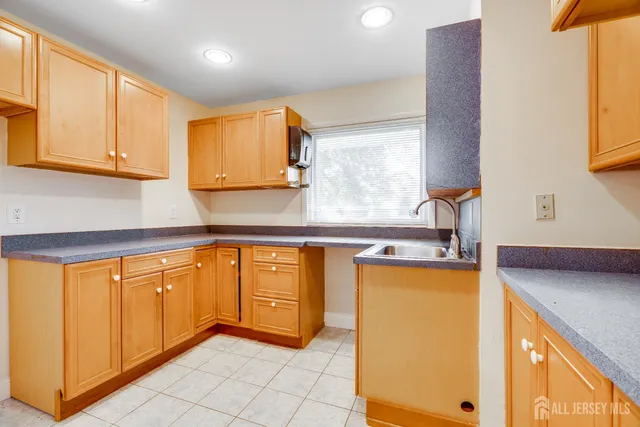 a kitchen with stainless steel appliances granite countertop a sink and a refrigerator