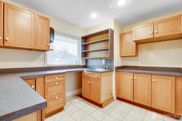 a kitchen with stainless steel appliances granite countertop a sink and cabinets