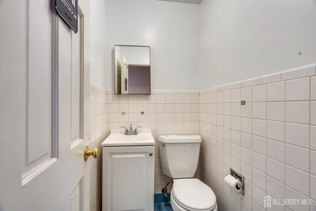 a bathroom with a toilet sink and mirror