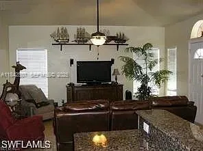 a kitchen with a refrigerator and a stove top oven