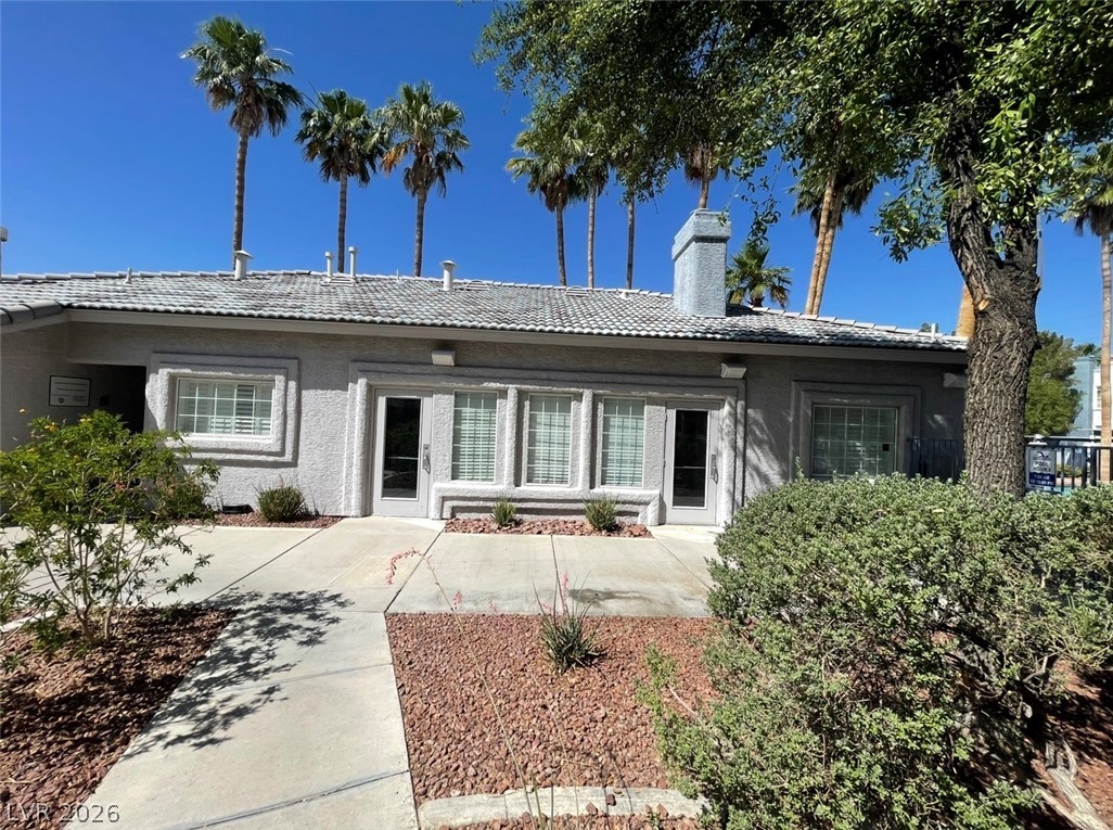 2201 Ramsgate Drive, Unit 915 Henderson, NV 89074 - Photo 11 of 36 A well-maintained clubhouse with stucco exterior and tile roof, offering a welcoming community space.