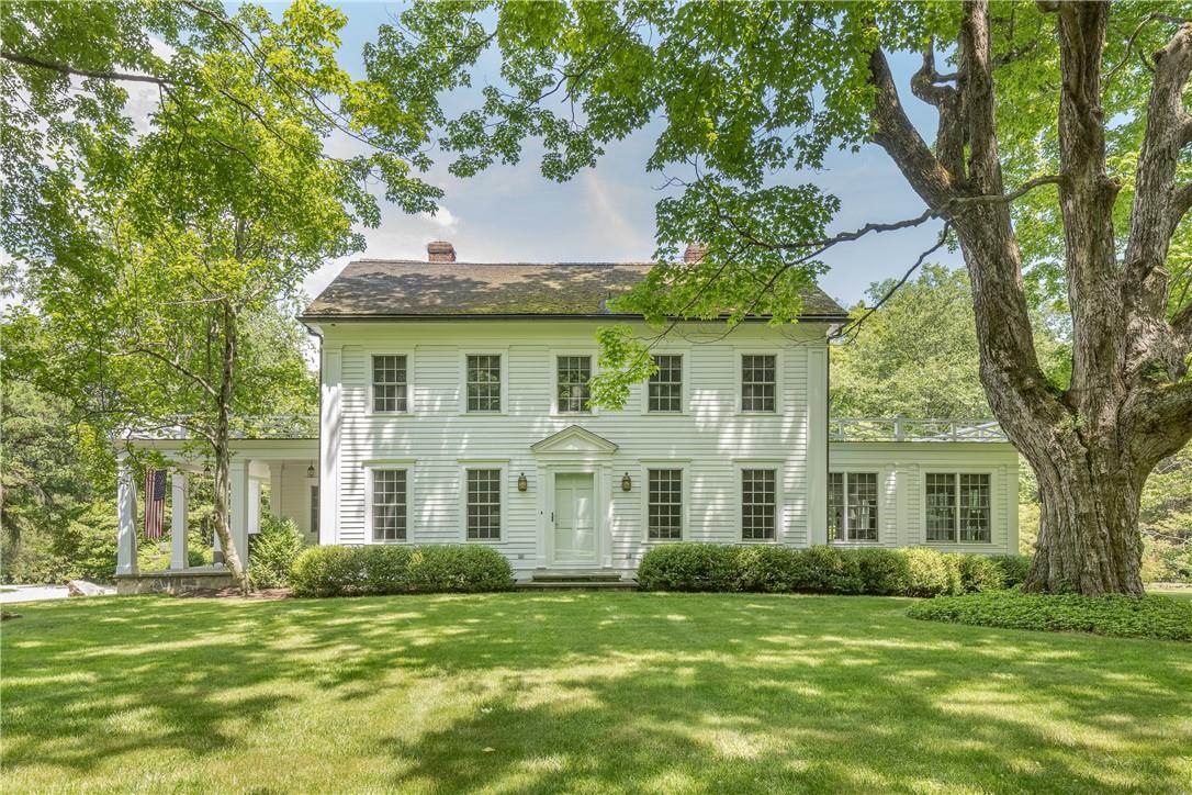 a view of a white house with a yard