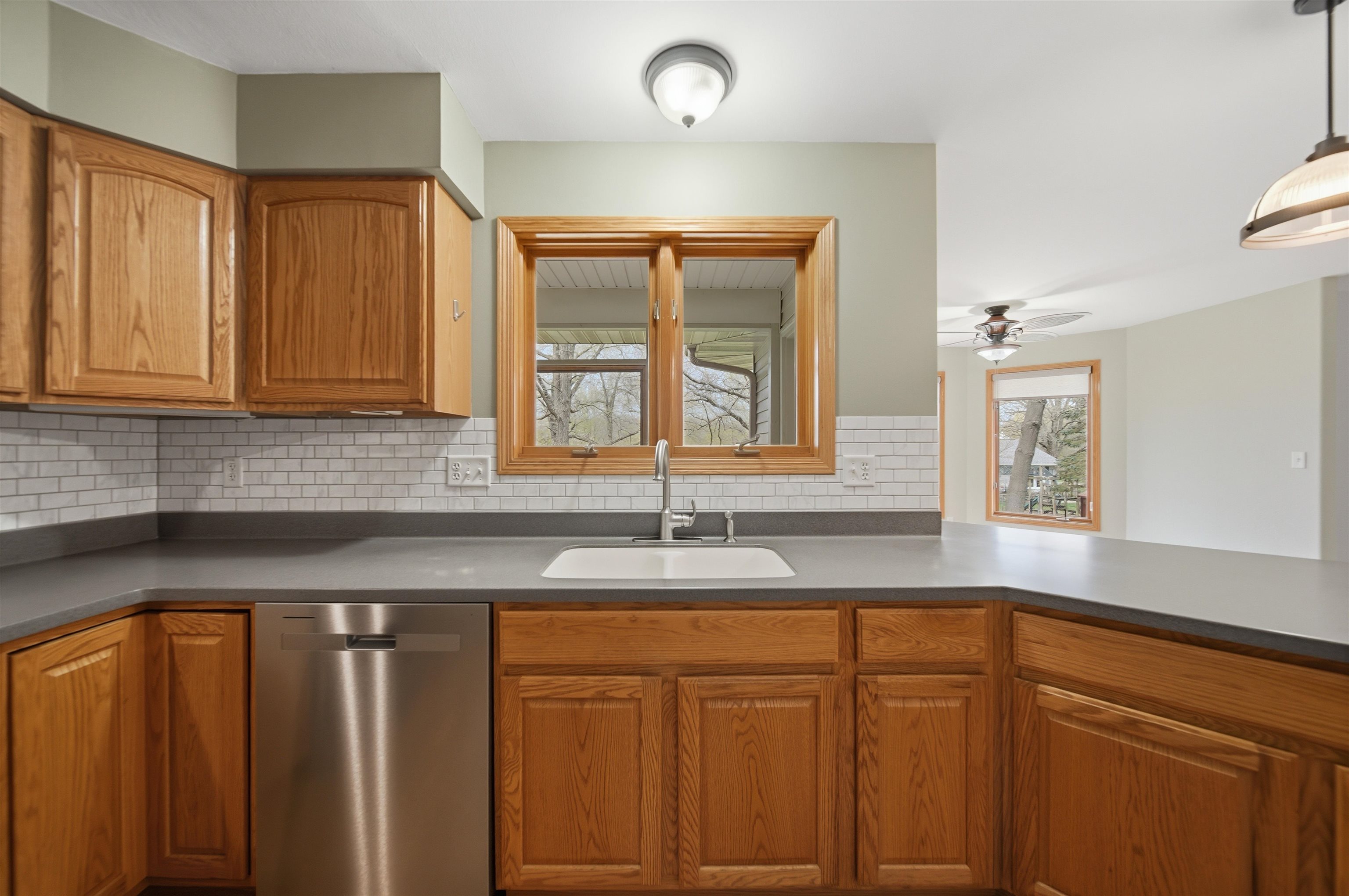 307 Portage Lane Dixon, IL 61021 - Photo 11 of 38 a kitchen with granite countertop cabinets sink and window