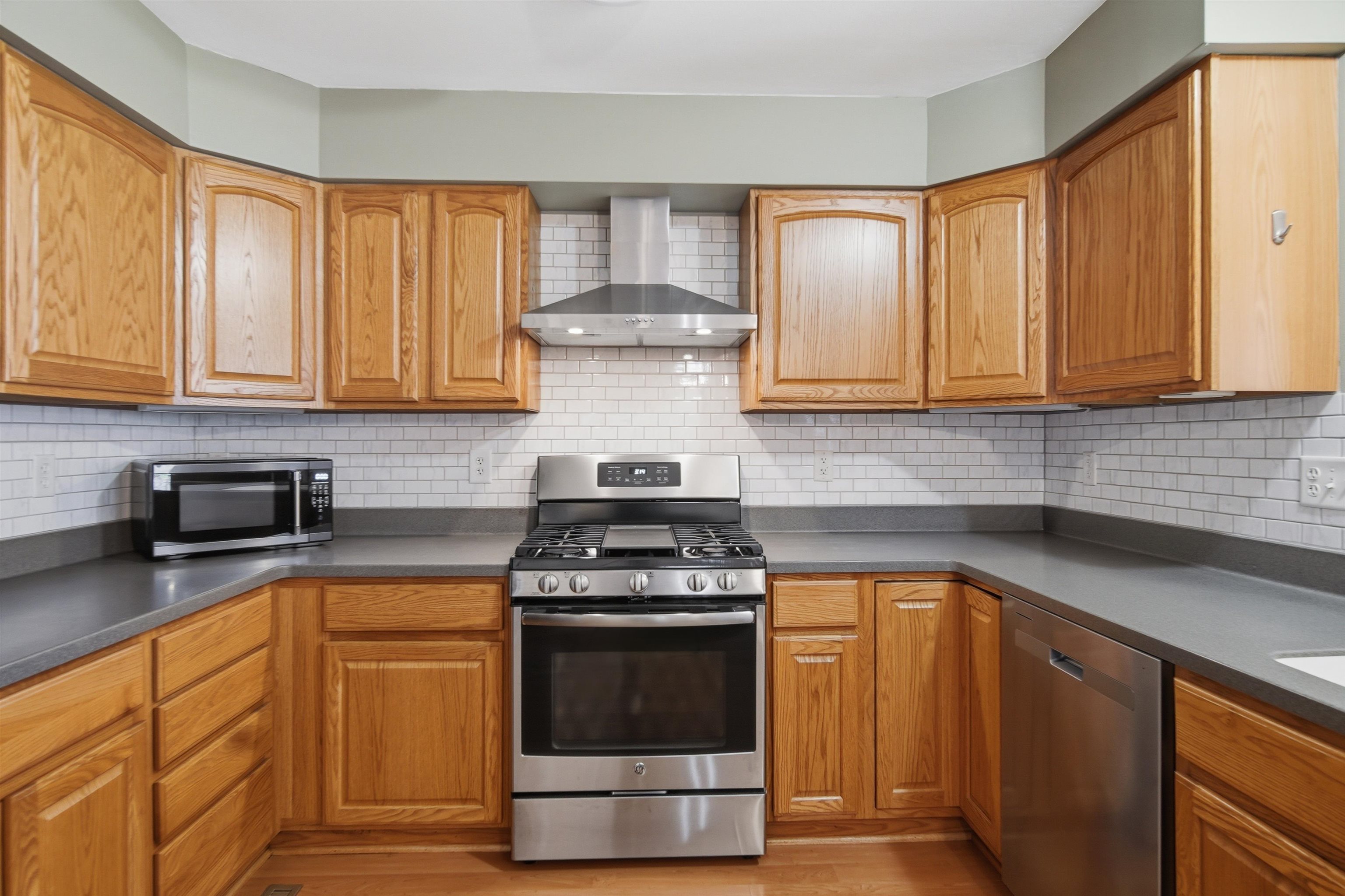 307 Portage Lane Dixon, IL 61021 - Photo 13 of 38 a kitchen with granite countertop wooden cabinets and a stove top oven