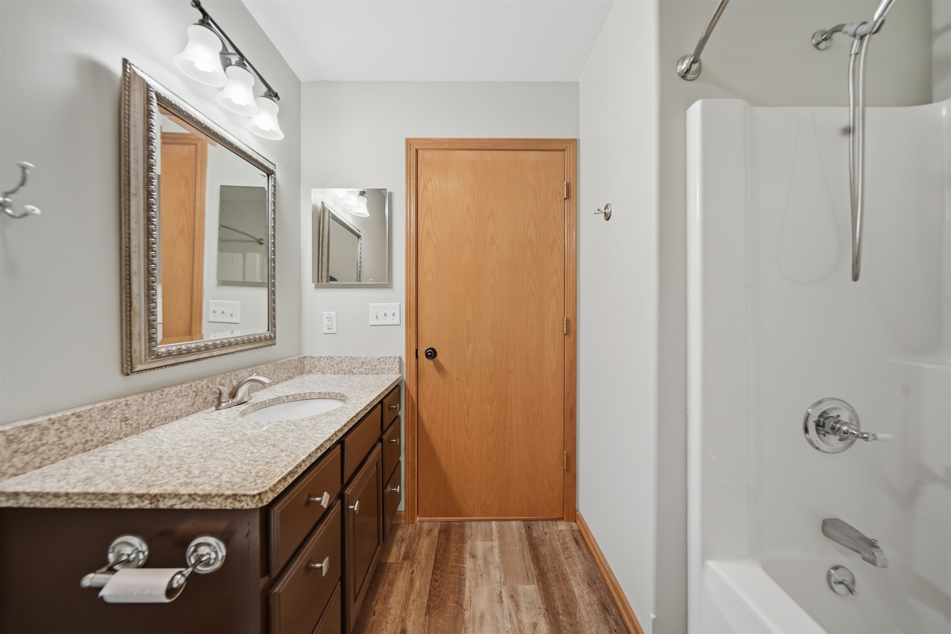 307 Portage Lane Dixon, IL 61021 - Photo 18 of 38 a bathroom with a granite countertop sink a mirror and a bathtub