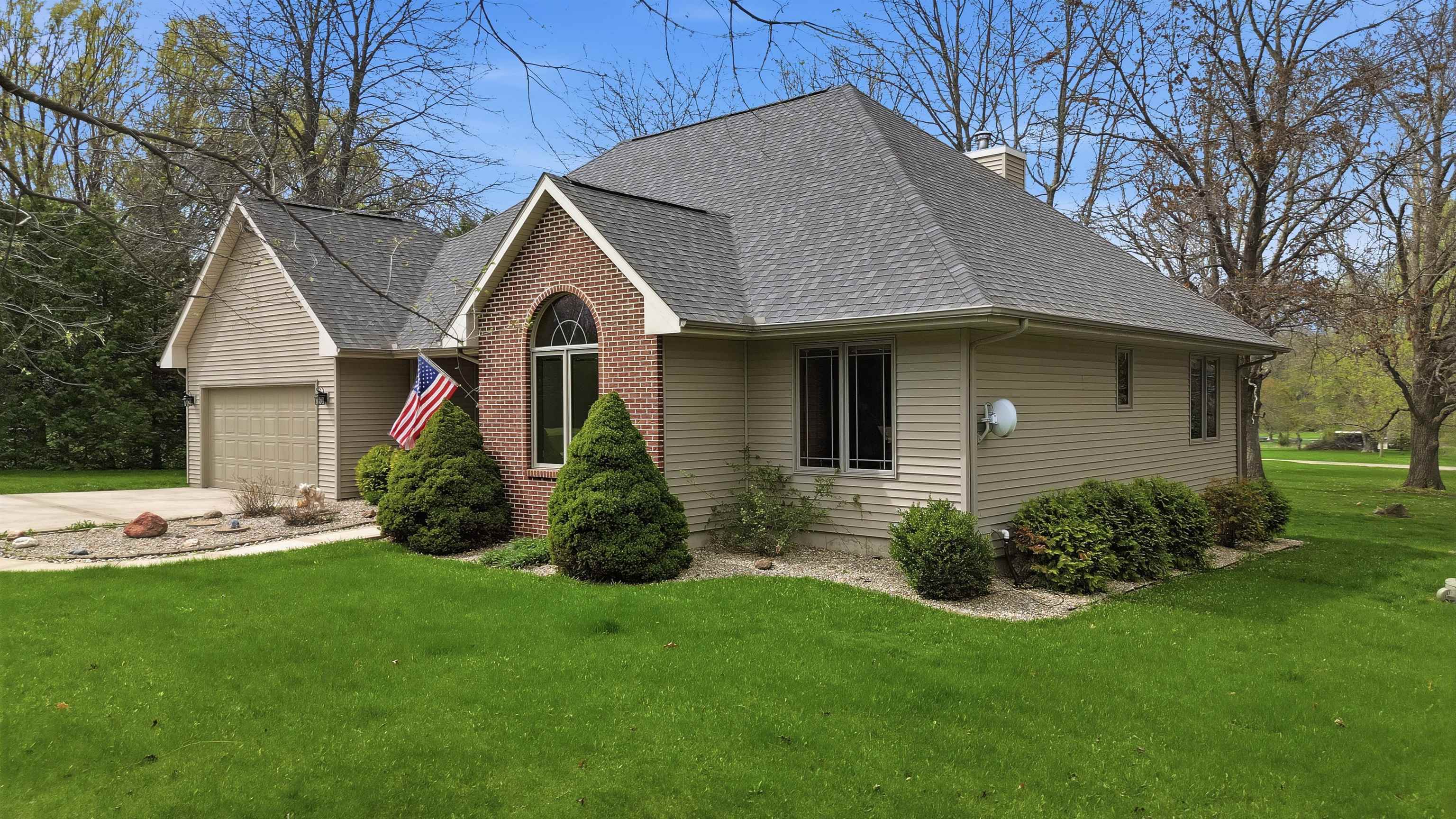 307 Portage Lane Dixon, IL 61021 - Photo 28 of 38 a front view of a house with a garden and plants