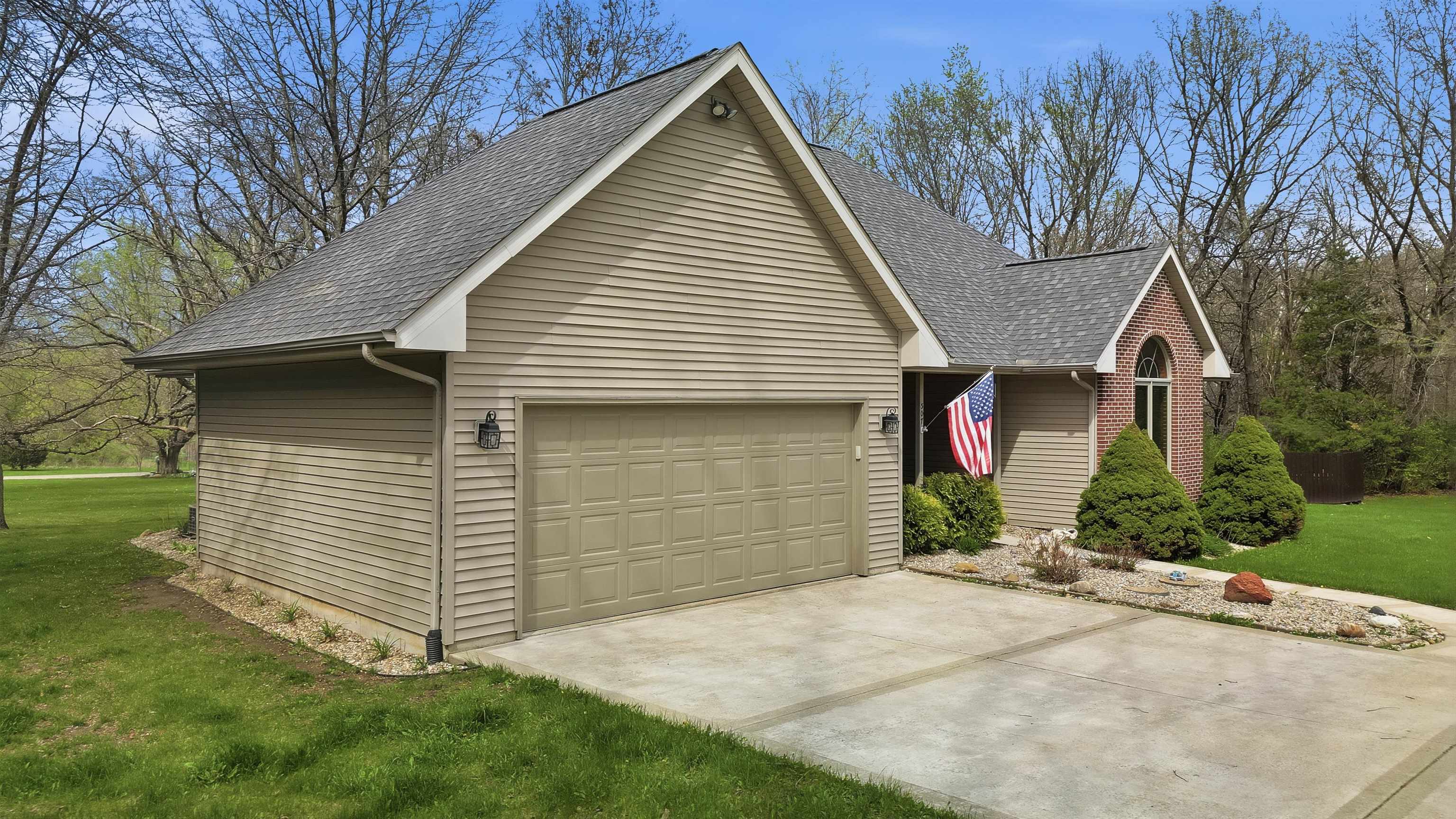 307 Portage Lane Dixon, IL 61021 - Photo 29 of 38 a front view of a house with a yard and garage