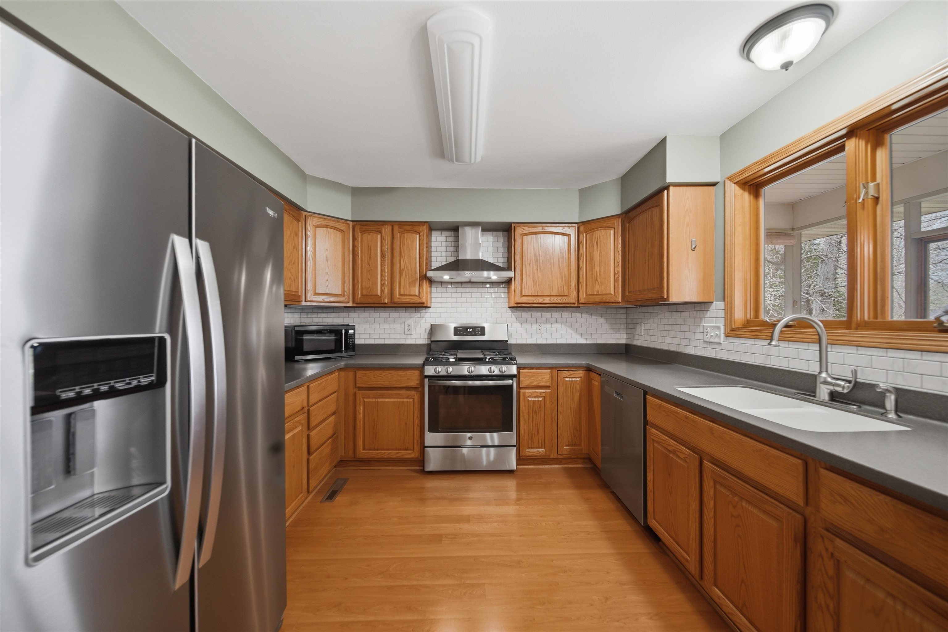 307 Portage Lane Dixon, IL 61021 - Photo 5 of 38 a kitchen with stainless steel appliances granite countertop a refrigerator sink and stove