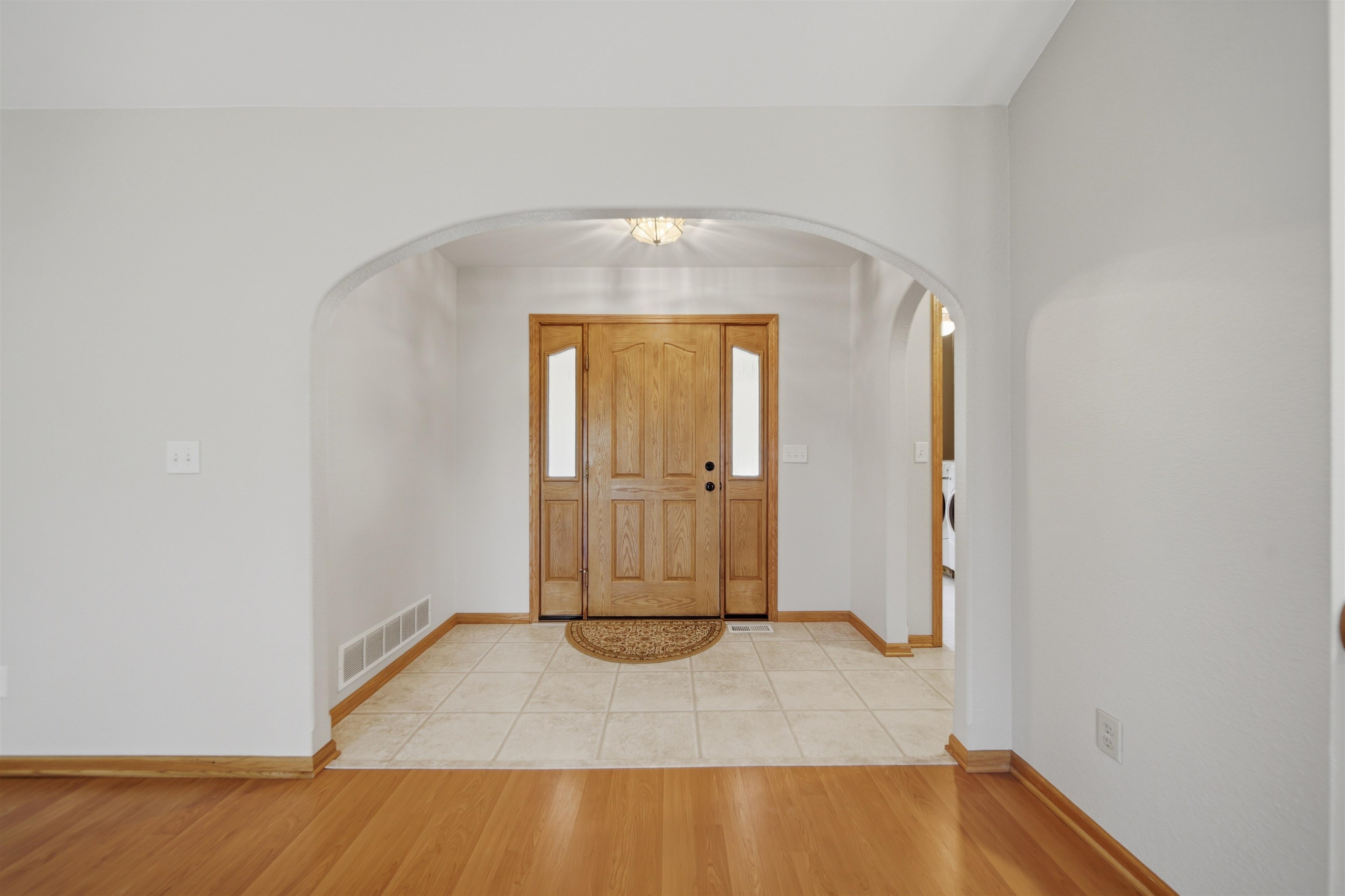 307 Portage Lane Dixon, IL 61021 - Photo 6 of 38 an empty room with wooden floor and windows