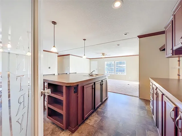a kitchen with stainless steel appliances granite countertop a sink and a stove