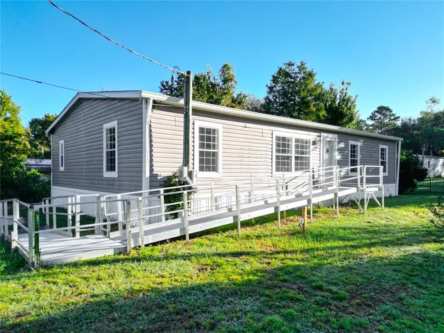 a view of an house with backyard space and sitting area