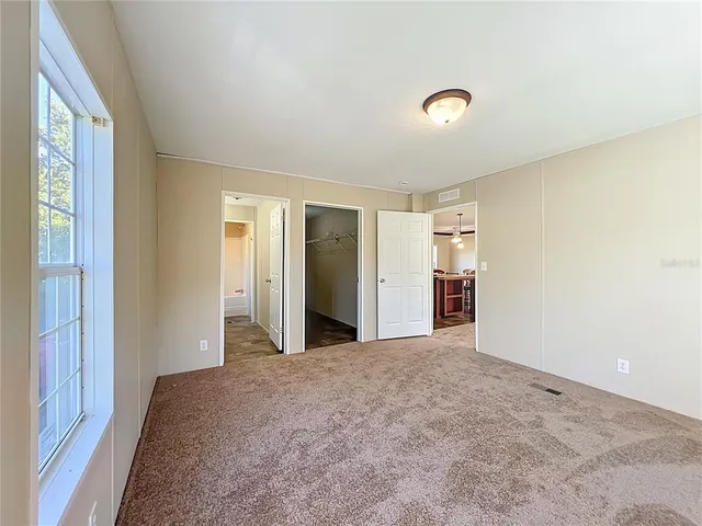 a view of a livingroom with wooden floor and a window