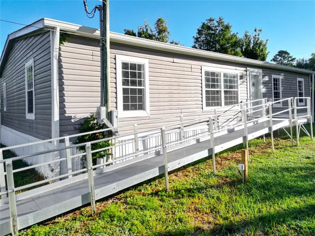 a house view with a swimming pool and sitting space