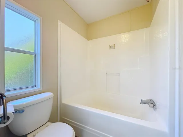 a bathroom with a toilet and a bathtub