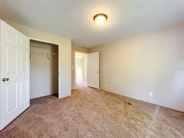 a bathroom with a granite countertop toilet a sink and a mirror