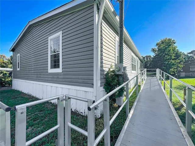 a view of balcony with wooden floor and fence
