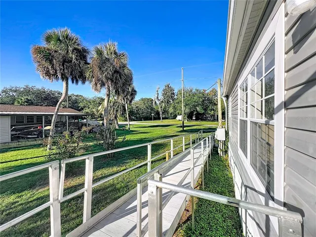 a view of a yard with wooden fence