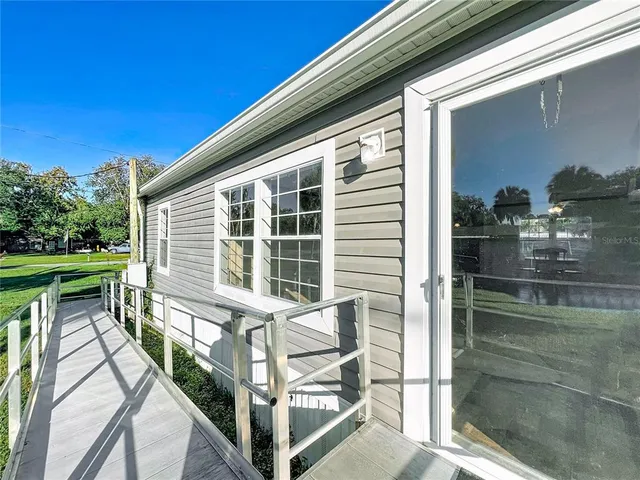 a view of a house with backyard and porch