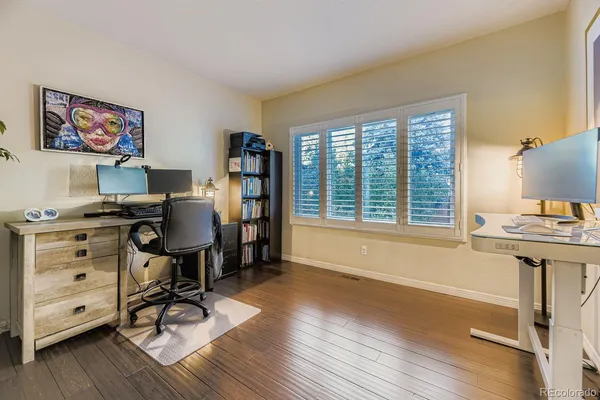 a view of a workspace with furniture and a window