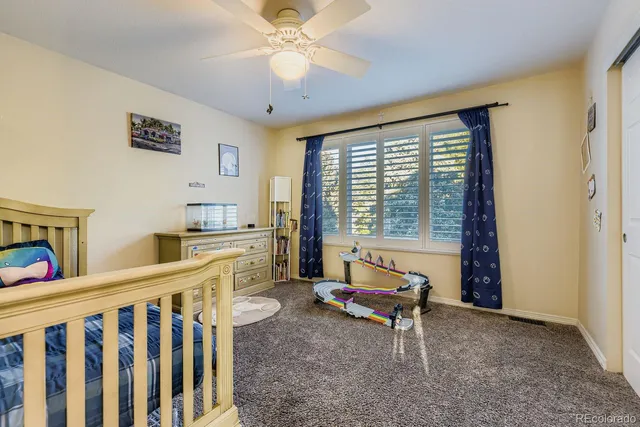 a bathroom with a granite countertop sink toilet and mirror