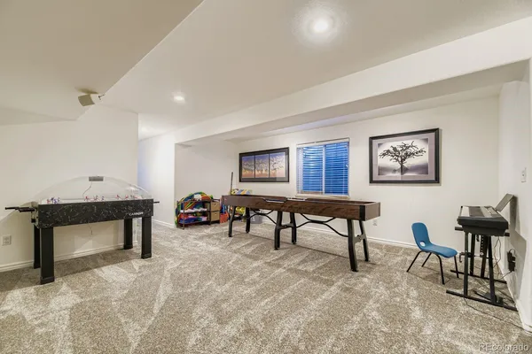 a kitchen with stainless steel appliances a dining table chairs and wooden floor