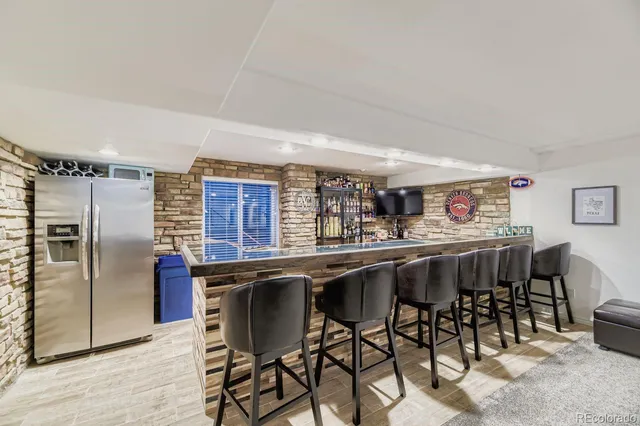 a view of a roof deck with table and chairs with wooden floor and fence