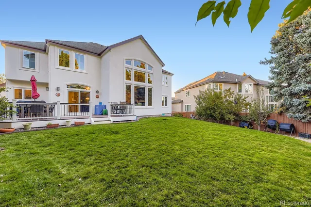 a view of a house with backyard and sitting area