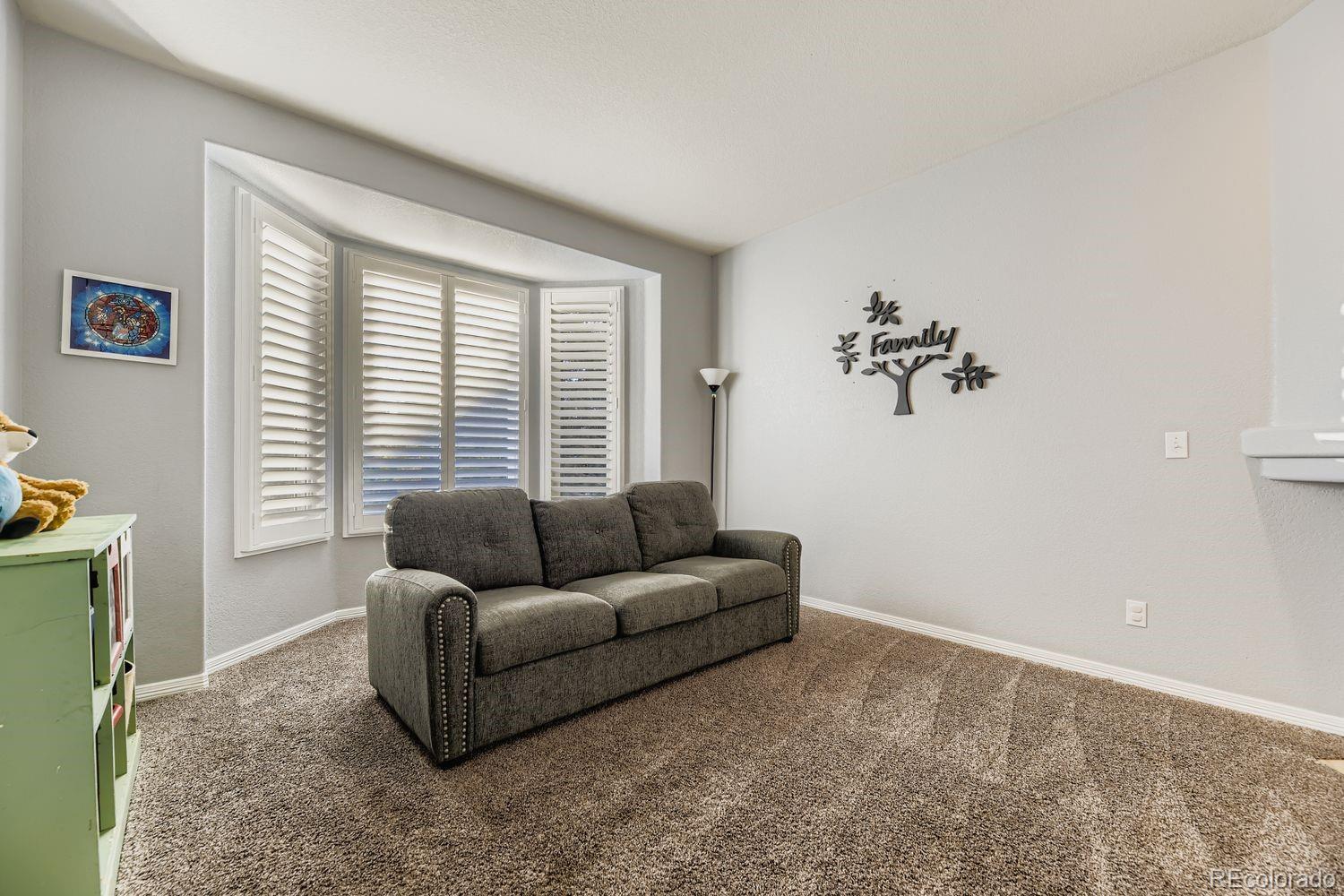 8356 Green Island Circle Lone Tree, CO 80124 - Photo 5 of 30 a living room with furniture and a window