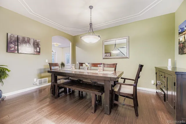 a dining room with furniture and wooden floor