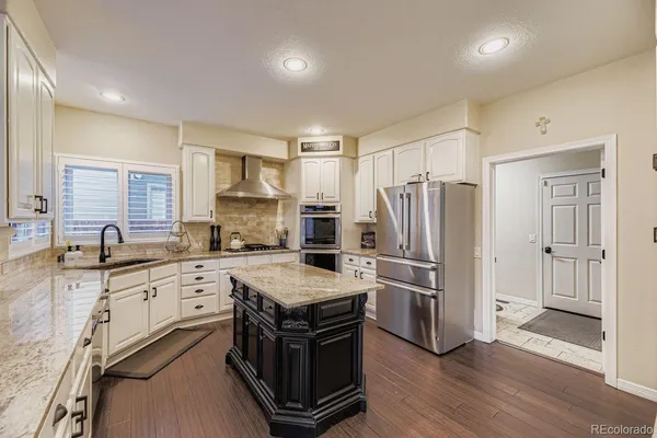 a kitchen with a sink stove and refrigerator