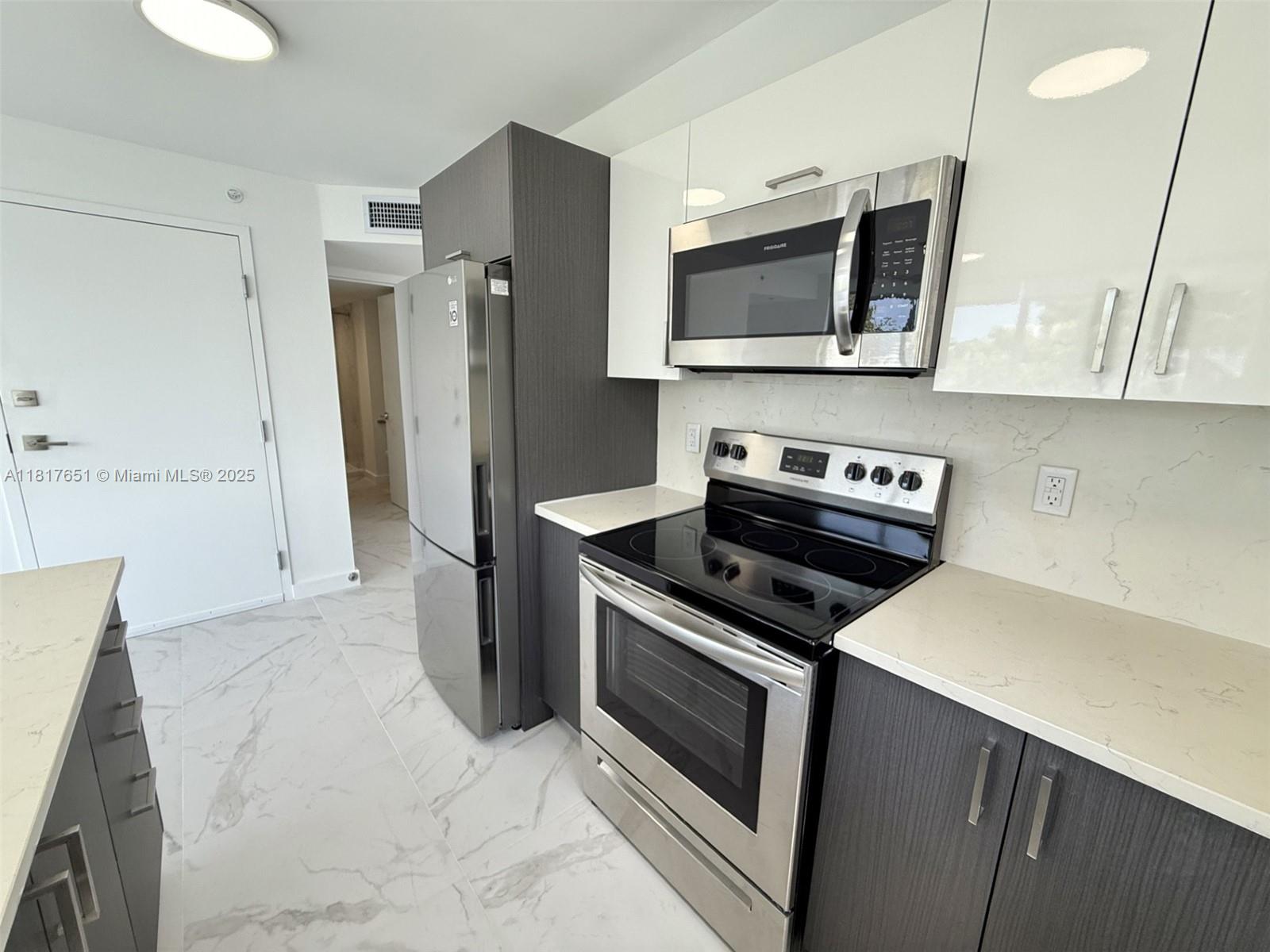 1552 Euclid Avenue, Unit 6 Miami Beach, FL 33139 - Photo 1 of 8 a kitchen with a stove and a microwave