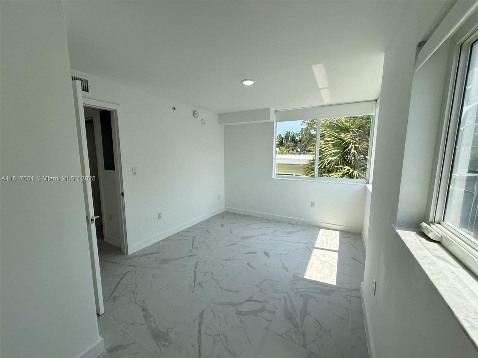 1552 Euclid Avenue, Unit 6 Miami Beach, FL 33139 - Photo 5 of 8 an empty room with windows