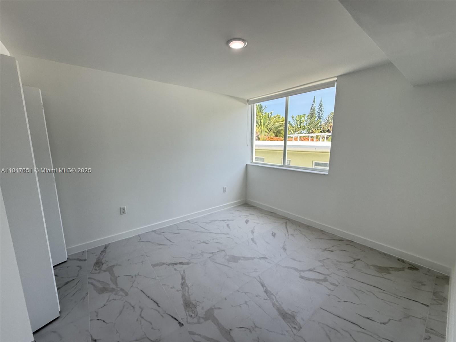 1552 Euclid Avenue, Unit 6 Miami Beach, FL 33139 - Photo 6 of 8 an empty room with a window